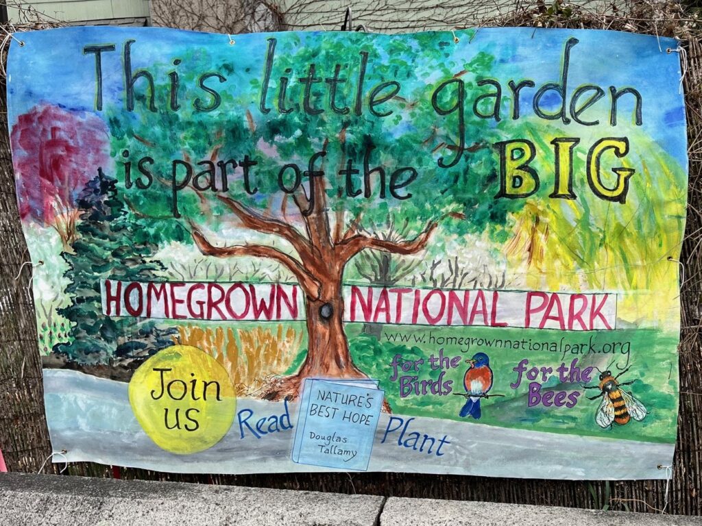 Banner centered on spreading tree. Text reads: This little garden is part of the Big Homegrown National Park. Join us. Read "Nature's Best Hope." Plant